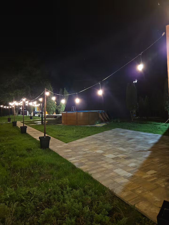 Garden pathway with night lighting and outdoor furniture