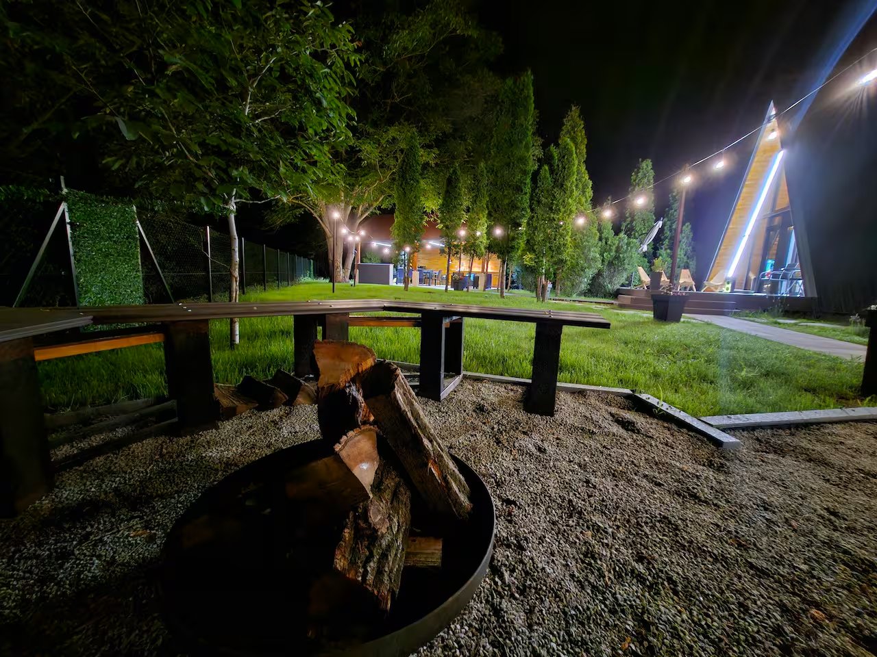 Full property overview with pool and garden at night