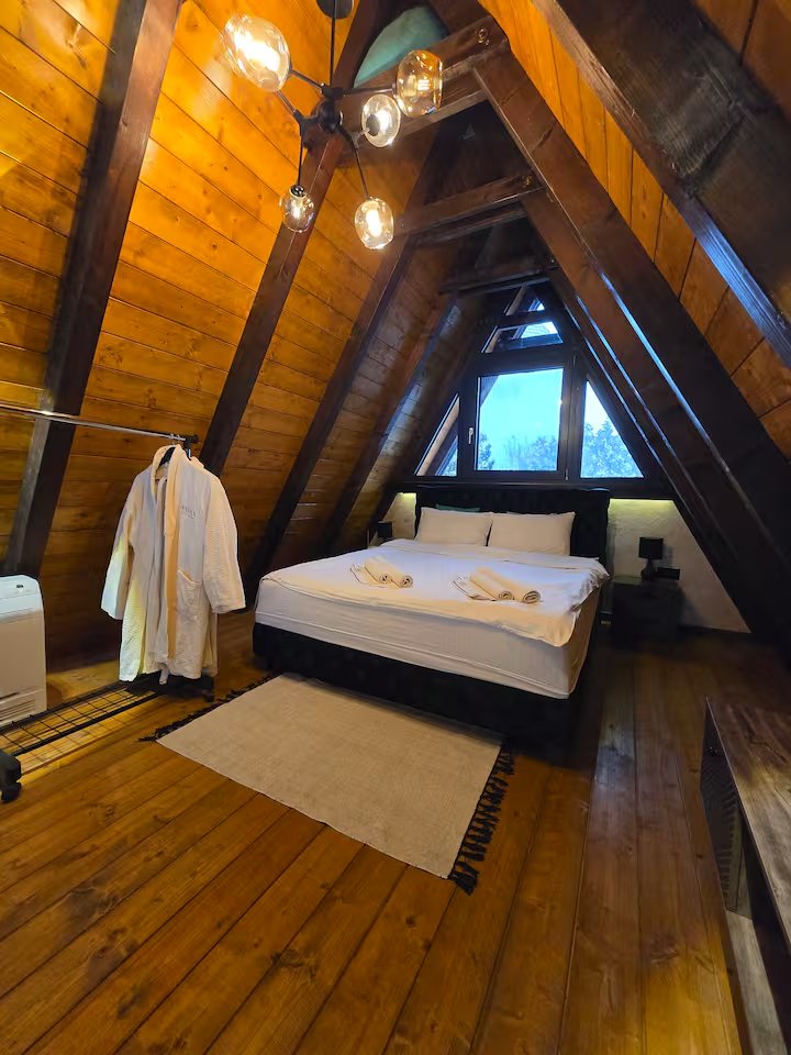 Upper bedroom area with warm wood and ambient light