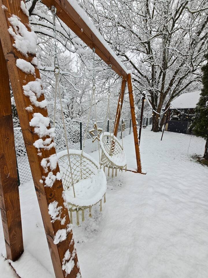 Outdoor swing set covered in fresh winter snow